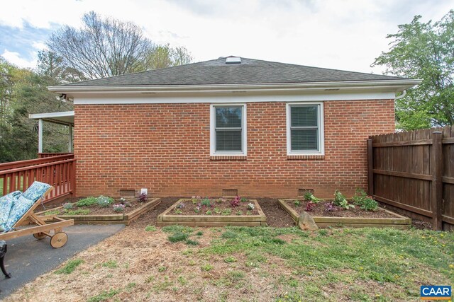 2750 Meriwether Dr, Charlottesville, VA 22901 - rear view of property with a vegetable garden, brick siding, crawl space, and a shingled roof