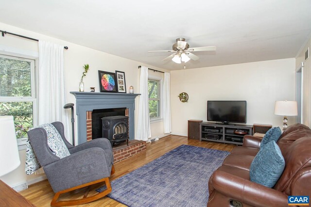 2750 Meriwether Dr, Charlottesville, VA 22901 - living area with a wood stove, wood finished floors, and ceiling fan