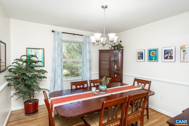 2750 Meriwether Dr, Charlottesville, VA 22901 - dining area with a chandelier, light wood-style flooring, and baseboards