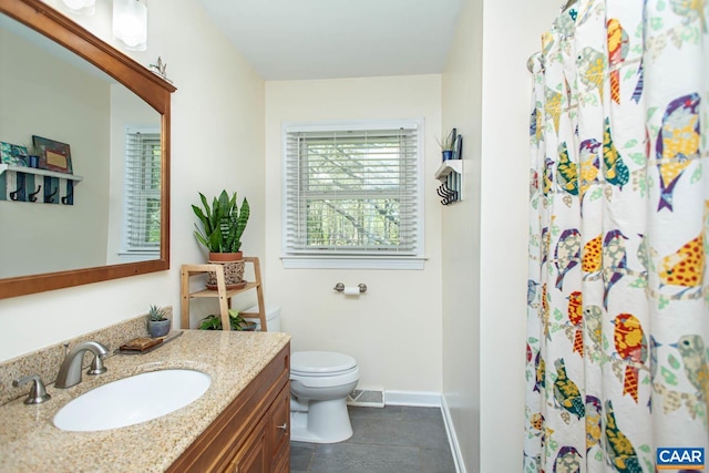 2750 Meriwether Dr, Charlottesville, VA 22901 - bathroom with toilet, vanity, baseboards, curtained shower, and tile patterned floors