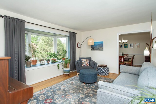 2750 Meriwether Dr, Charlottesville, VA 22901 - living area featuring a chandelier, wood finished floors, and baseboards