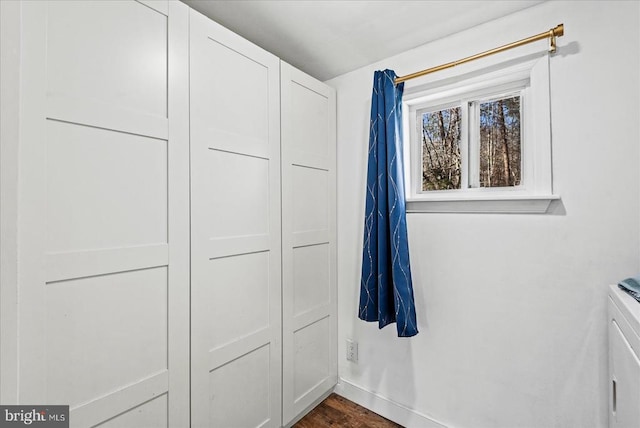 197 Holly Grove Ct, Bumpass, VA 23024 - washroom featuring separate washer and dryer, dark wood-style flooring, cabinet space, and baseboards