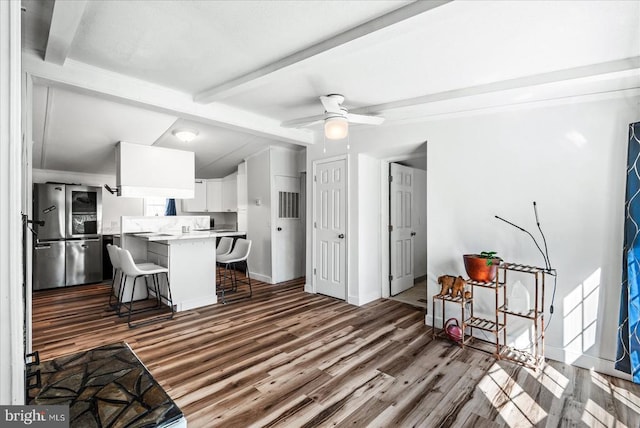 197 Holly Grove Ct, Bumpass, VA 23024 - kitchen with smart refrigerator, a breakfast bar, wood finished floors, a peninsula, and light countertops