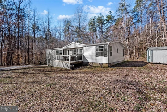 197 Holly Grove Ct, Bumpass, VA 23024 - manufactured / mobile home featuring a storage unit, crawl space, an outdoor structure, and a deck