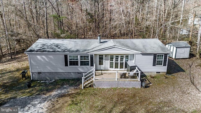 197 Holly Grove Ct, Bumpass, VA 23024 - manufactured / mobile home featuring crawl space, a storage unit, an outdoor structure, a deck, and a shingled roof