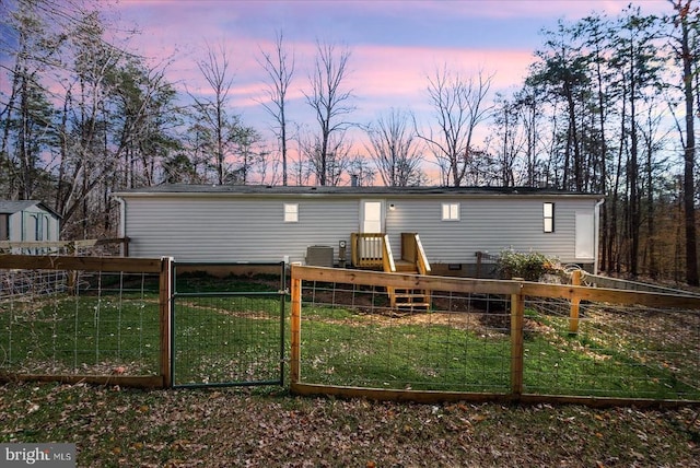 197 Holly Grove Ct, Bumpass, VA 23024 - back of property at dusk with a gate and crawl space