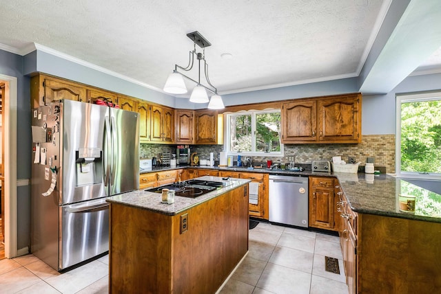 115 Pheasant Rd, Mcgaheysville, VA 22840 - kitchen featuring appliances with stainless steel finishes, brown cabinetry, tasteful backsplash, dark stone counters, and ornamental molding