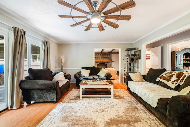 115 Pheasant Rd, Mcgaheysville, VA 22840 - living room with a ceiling fan, wood finished floors, ornamental molding, and a brick fireplace