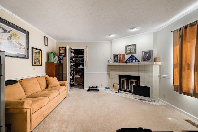 115 Pheasant Rd, Mcgaheysville, VA 22840 - living area with crown molding, carpet floors, a tiled fireplace, a textured ceiling, and baseboards