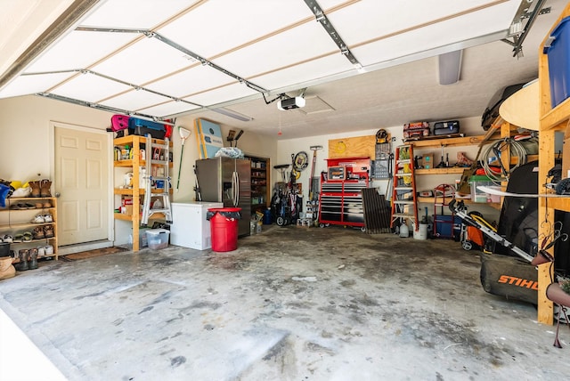 115 Pheasant Rd, Mcgaheysville, VA 22840 - garage featuring a garage door opener and stainless steel fridge with ice dispenser