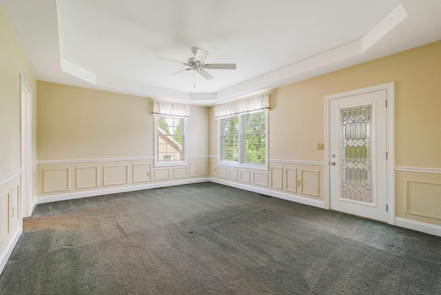 2554 Village Dr, Waynesboro, VA 22980 - carpeted empty room with a raised ceiling, a ceiling fan, a decorative wall, and a wainscoted wall