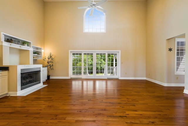 2554 Village Dr, Waynesboro, VA 22980 - unfurnished living room with a towering ceiling, a fireplace, wood finished floors, and a ceiling fan