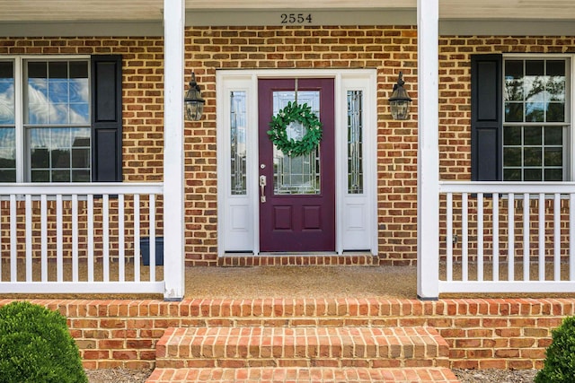 2554 Village Dr, Waynesboro, VA 22980 - view of exterior entry featuring a porch and brick siding