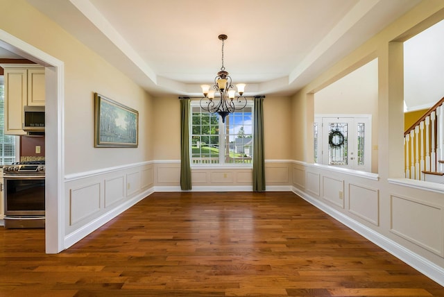 2554 Village Dr, Waynesboro, VA 22980 - unfurnished dining area featuring a chandelier, dark wood-style floors, a decorative wall, wainscoting, and a raised ceiling