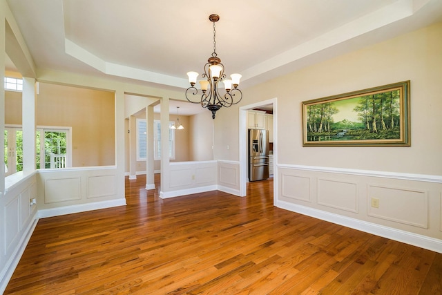 2554 Village Dr, Waynesboro, VA 22980 - unfurnished room with a chandelier, a decorative wall, light wood-type flooring, a raised ceiling, and wainscoting