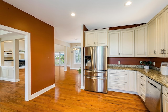 2554 Village Dr, Waynesboro, VA 22980 - kitchen featuring appliances with stainless steel finishes, light wood-type flooring, a chandelier, recessed lighting, and stone countertops