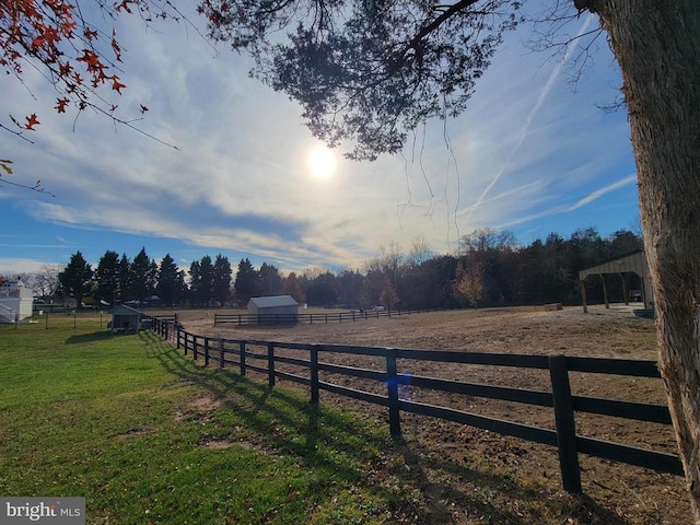 view of yard featuring an enclosed riding area, a rural view, and an outdoor structure