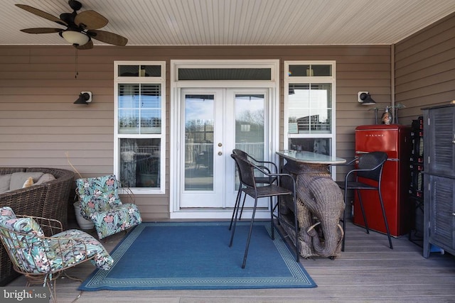 wooden terrace featuring french doors and a ceiling fan