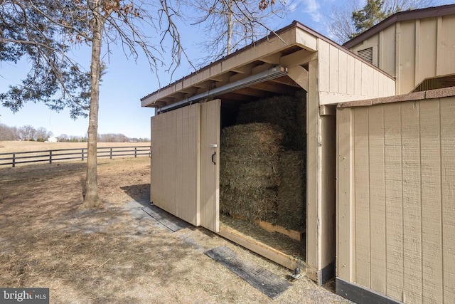 view of outdoor structure featuring fence and an outdoor structure