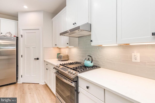 8532 Sylvannah Dr, Spotsylvania, VA 22551 - kitchen with stainless steel appliances, under cabinet range hood, white cabinetry, light wood-type flooring, and light countertops
