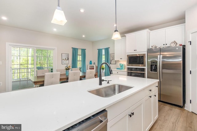 8532 Sylvannah Dr, Spotsylvania, VA 22551 - kitchen featuring a sink, stainless steel appliances, pendant lighting, light countertops, and recessed lighting