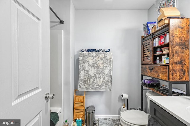 bathroom with a shower, baseboards, toilet, marble look tiles, and vanity