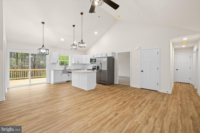 358 Hemlock Ln, Mineral, VA 23117 - kitchen with stainless steel appliances, ceiling fan, a center island, light countertops, and high vaulted ceiling
