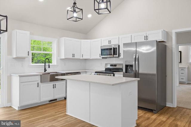 358 Hemlock Ln, Mineral, VA 23117 - kitchen with appliances with stainless steel finishes, a sink, white cabinets, light wood-style flooring, and high vaulted ceiling