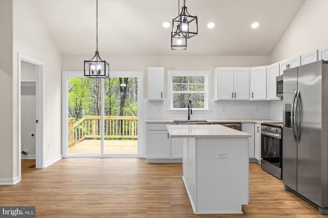 358 Hemlock Ln, Mineral, VA 23117 - kitchen with stainless steel appliances, lofted ceiling, a center island, light countertops, and a sink