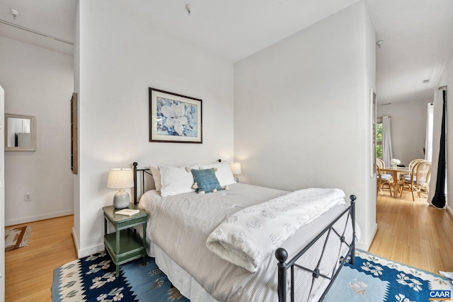 bedroom featuring wood finished floors and baseboards