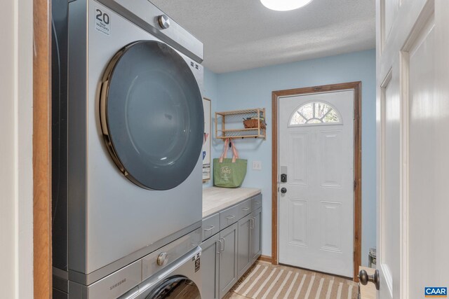 2 Amethyst Rd, Palmyra, VA 22963 - washroom featuring stacked washing machine and dryer, cabinet space, and a textured ceiling
