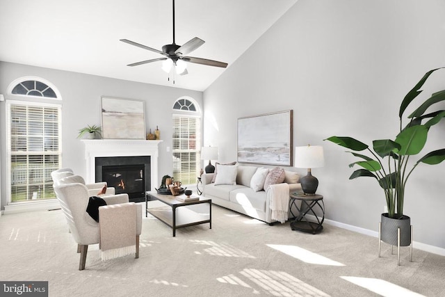 6304 Dranesville Dr W, Fredericksburg, VA 22407 - carpeted living area featuring baseboards, healthy amount of natural light, a glass covered fireplace, high vaulted ceiling, and ceiling fan