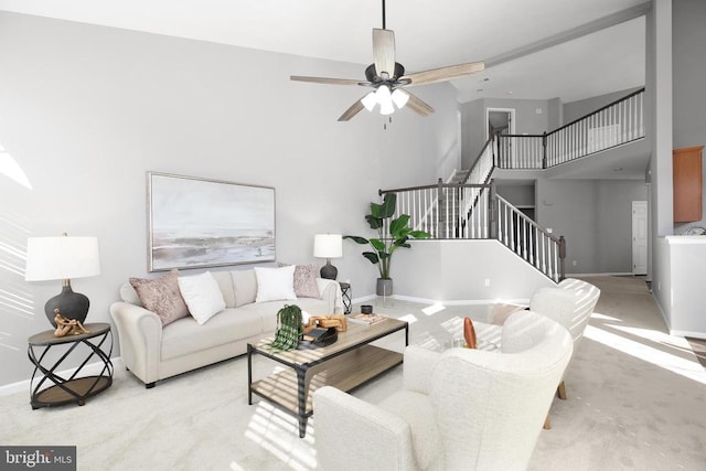 6304 Dranesville Dr W, Fredericksburg, VA 22407 - living area featuring stairs, a high ceiling, light carpet, baseboards, and ceiling fan