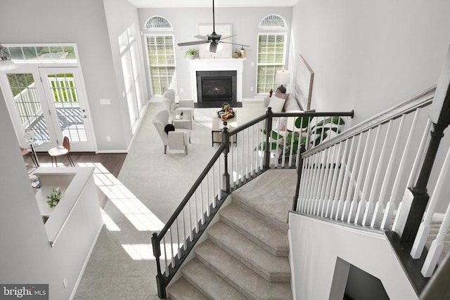 6304 Dranesville Dr W, Fredericksburg, VA 22407 - stairs featuring a ceiling fan, a fireplace with flush hearth, baseboards, and carpet