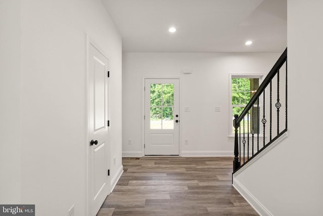  - foyer featuring wood finished floors, stairway, and recessed lighting