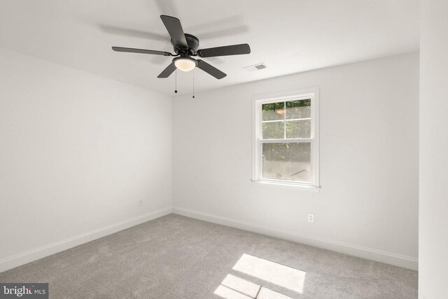  - carpeted spare room with ceiling fan and baseboards