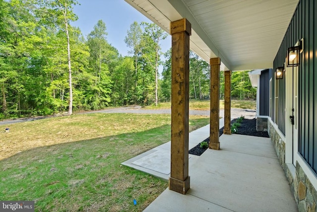  - view of green lawn featuring a wooded view