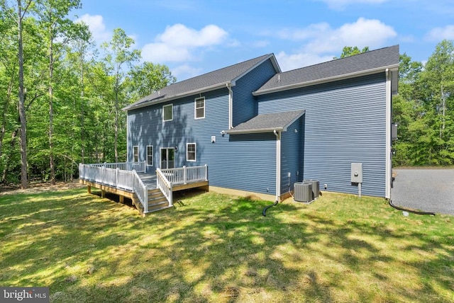  - back of house with a deck and a lawn