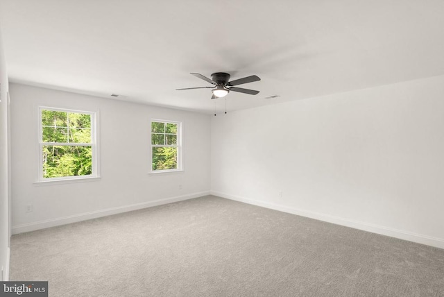  - carpeted empty room featuring a ceiling fan and baseboards