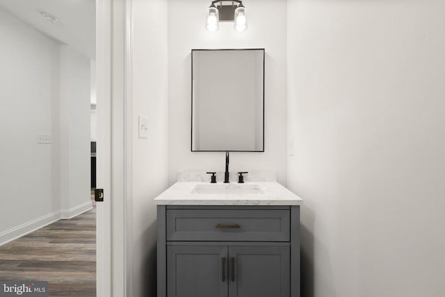  - bathroom featuring wood finished floors, vanity, and baseboards