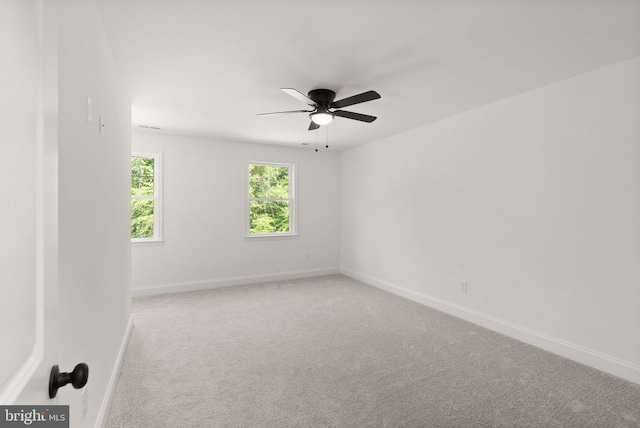  - carpeted spare room with baseboards and ceiling fan