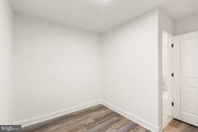  - spare room featuring wood finished floors and baseboards