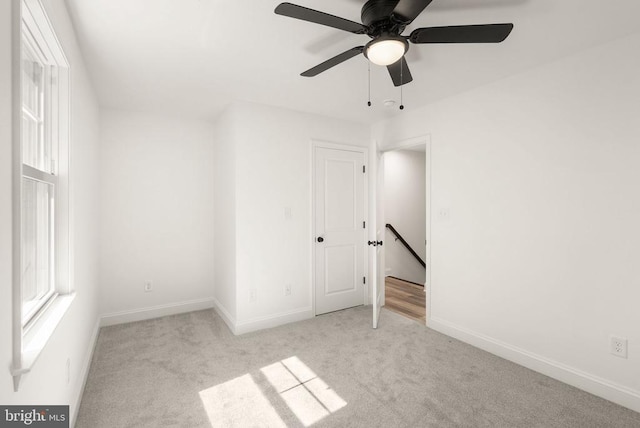  - carpeted spare room with plenty of natural light and a ceiling fan