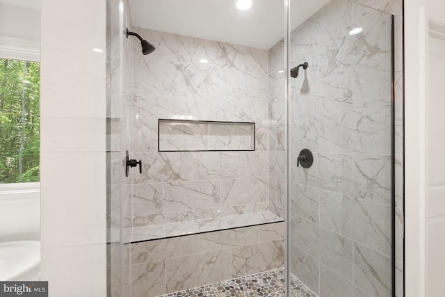  - bathroom featuring tiled shower and recessed lighting