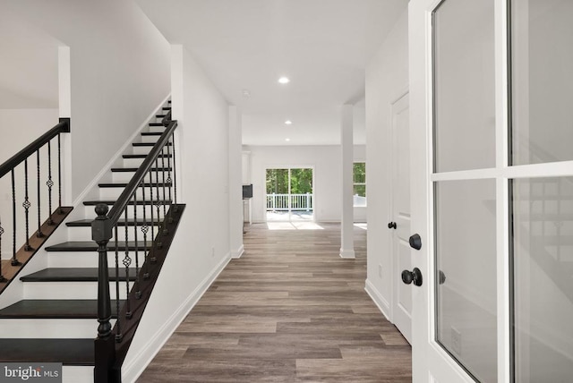  - hallway with wood finished floors, recessed lighting, and stairs