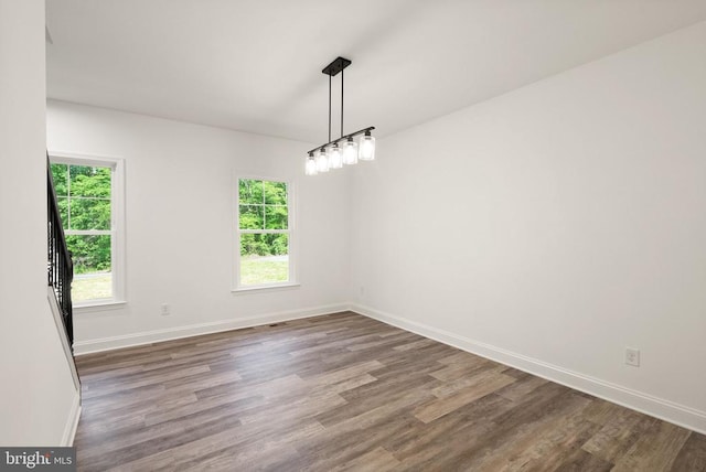  - unfurnished room with plenty of natural light and wood finished floors