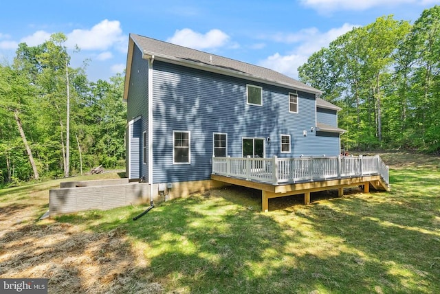  - back of property with a deck and a lawn