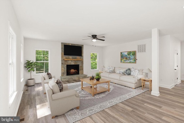  - living area featuring a ceiling fan, wood finished floors, a fireplace, and baseboards