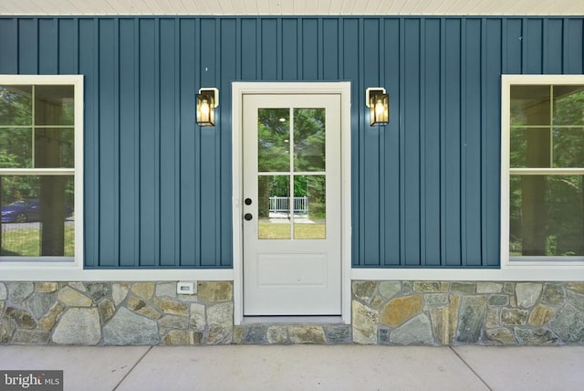  - property entrance with board and batten siding and stone siding