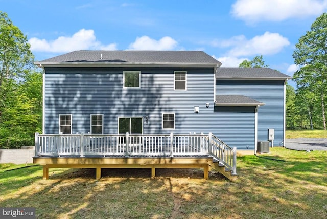  - back of house featuring a wooden deck, cooling unit, and a lawn